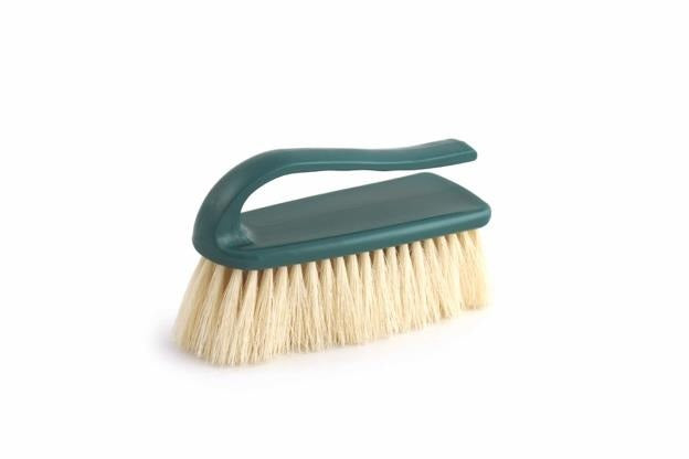 Green brush with beige bristles on a white background
