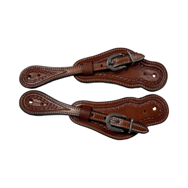 Pair of brown leather spurs on a white background