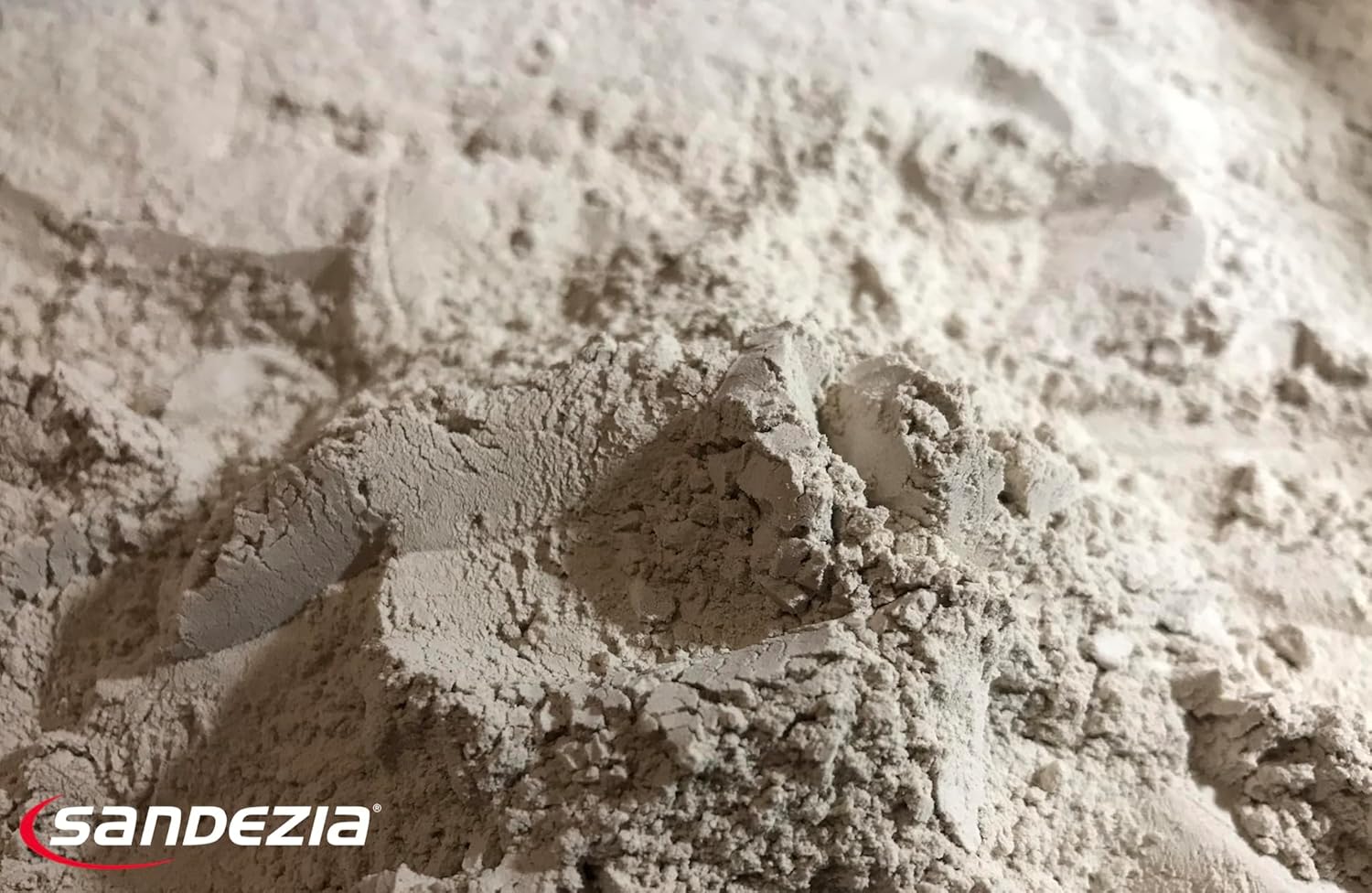 Close-up of sandezia bedding powder with 'sandezia' logo in the corner