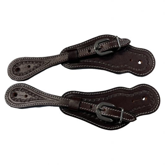 Pair of brown leather spurs on a white background
