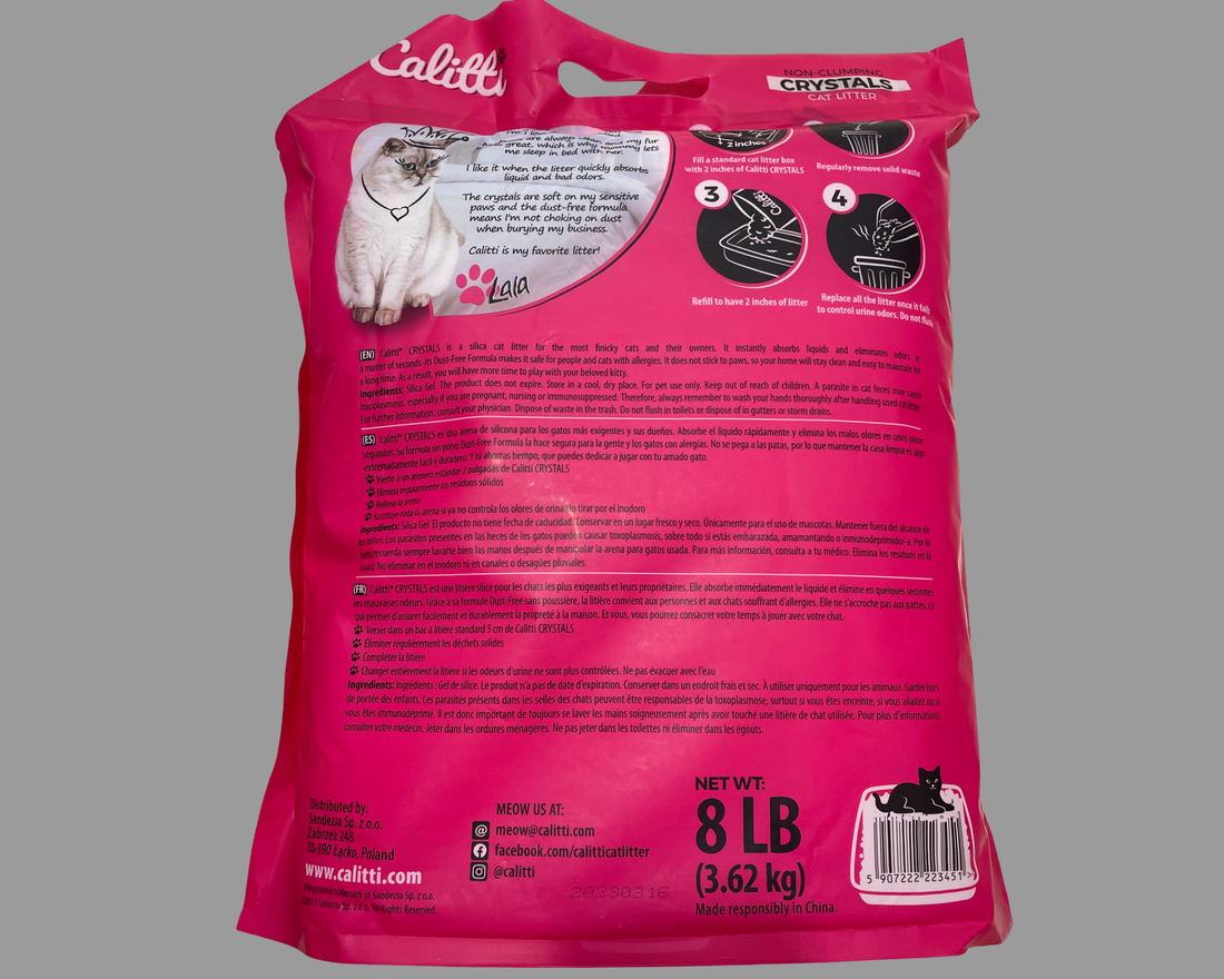 Calitti cat litter non clumping crystals bag next to a cat using a litter box indoors.